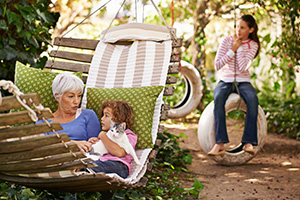 grandmother and grandkids enjoying no pests in salina kansas backyard after green pest control service